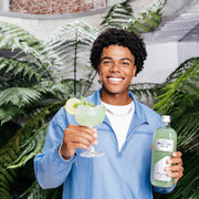 Bottle with Basil Breeze mocktail 99cl and mocktail glass filled with the Basil Breeze mocktail