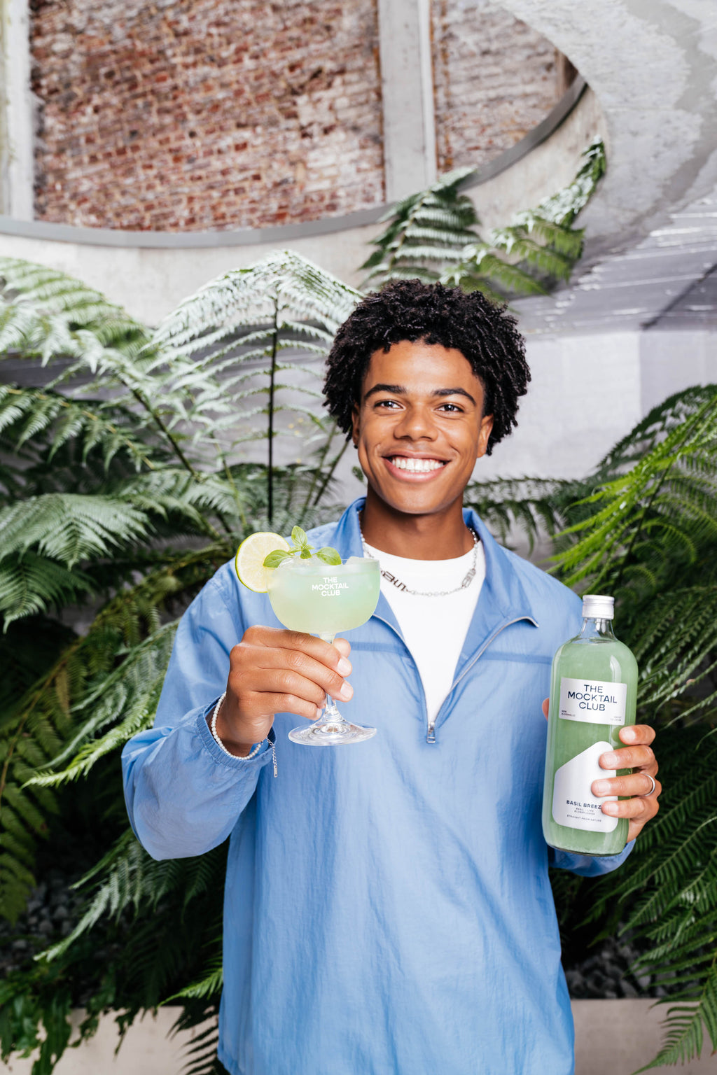 Bottle with Basil Breeze mocktail 99cl and mocktail glass filled with the Basil Breeze mocktail