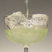 Mocktail glass filled with the Basil Breeze mocktail.