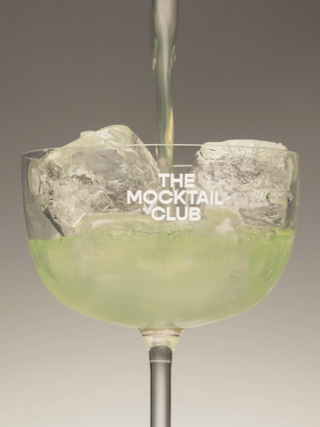 Mocktail glass filled with the Basil Breeze mocktail.