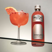 Small bottle of 49 cl Grapefruit Grace and The Mocktail Club glass filled with this mocktail