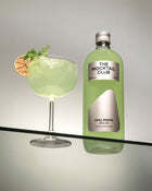 Bottle with Basil Breeze mocktail 99cl and mocktail glass filled with the Basil Breeze mocktail