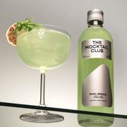 Bottle with Basil Breeze mocktail 49cl and mocktail glass filled with Basil Breeze mocktail